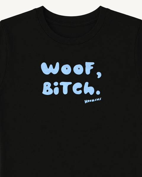 Close-up of the 'Woof, Bitch.' baby blue bubble letters and the small Hoomans signature on the black baby tee chest