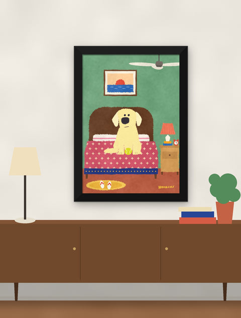 Black framed labrador poster hung above a walnut console with a lamp, books and a plant