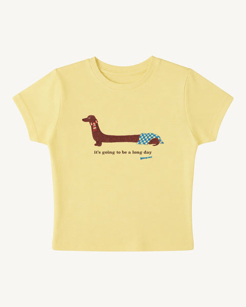 Butter yellow baby tee with a crayon dachshund in a red scarf and 'it's going to be a long day', front flat lay, Hoomans India