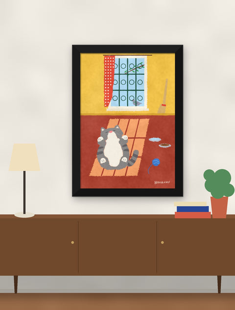 Black framed indian billi poster hung above a walnut console with a lamp, books and a plant