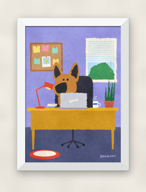 German Shepherd at the Desk art print in a white frame on a plain wall