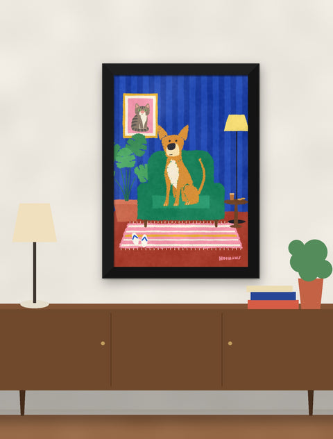 Black framed indie poster hung above a walnut console with a lamp, books and a plant