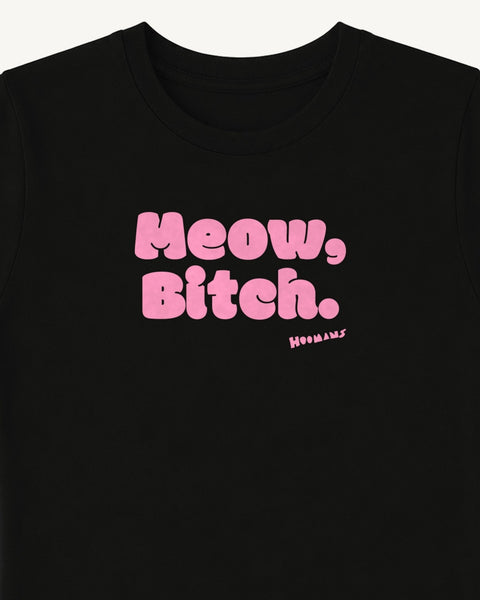 Close-up of the 'Meow, Bitch.' pink bubble letters and the small Hoomans signature on the black baby tee chest