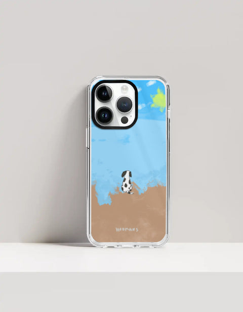 Hoomans Out of Office iPhone case — hand-painted spotted dog on a beach facing the sea, on iPhone 14 Pro mockup
