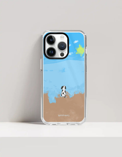 Hoomans Out of Office iPhone case — hand-painted spotted dog on a beach facing the sea, on iPhone 14 Pro Max mockup