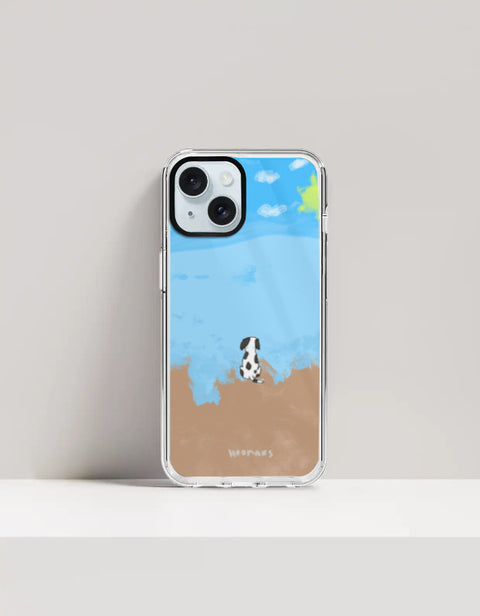 Hoomans Out of Office iPhone case — hand-painted spotted dog on a beach facing the sea, on iPhone 15 mockup
