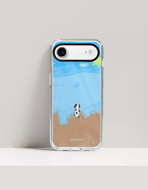 Hoomans Out of Office iPhone case — hand-painted spotted dog on a beach facing the sea, on iPhone 17 Air mockup