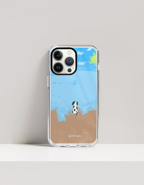 Hoomans Out of Office iPhone case — hand-painted spotted dog on a beach facing the sea, on iPhone 13 Pro mockup