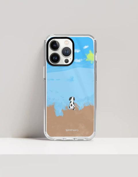 Hoomans Out of Office iPhone case — hand-painted spotted dog on a beach facing the sea, on iPhone 13 Pro Max mockup