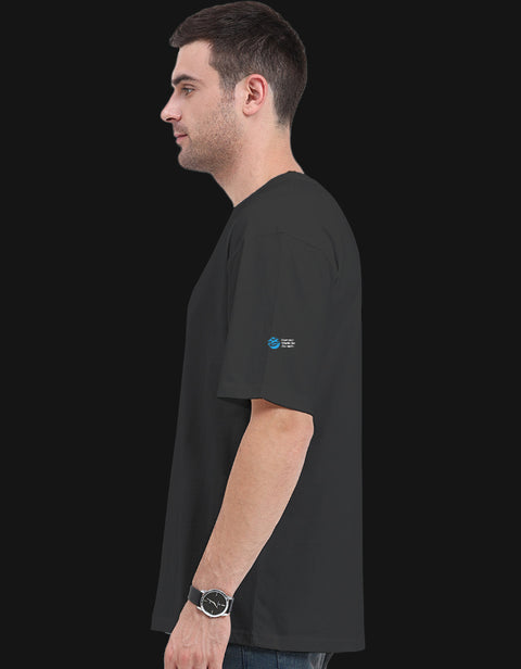 Dogesh Bhai Ki Gang oversized tee in black, side view with the Humane World for Animals India mark on the left sleeve