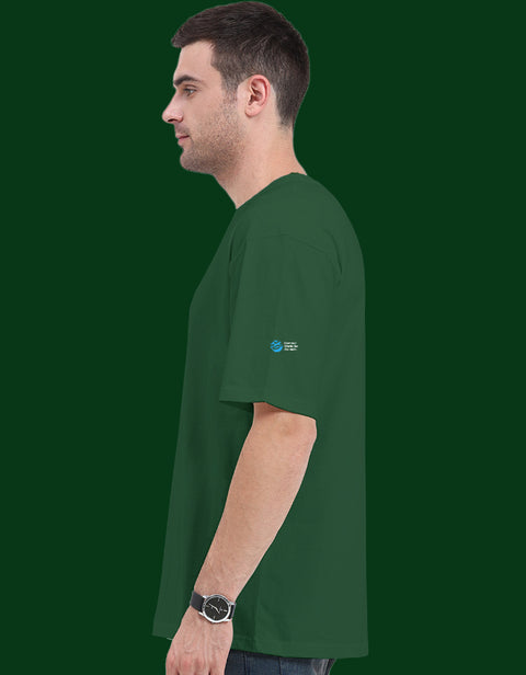 Dogesh Bhai Ki Gang oversized tee in bottle green, side view with the Humane World for Animals India mark on the left sleeve