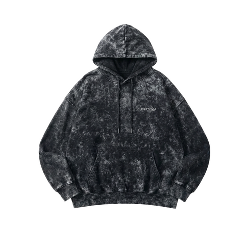 Black  acid-wash hoodie with HOOMANS brand logo  with a blurred background