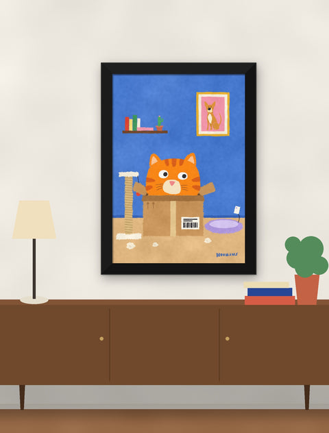 Black framed orange tabby cat poster hung above a walnut console with a lamp, books and a plant