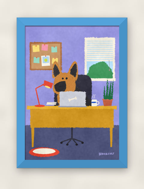 German Shepherd at the Desk art print in a sky blue frame on a plain wall
