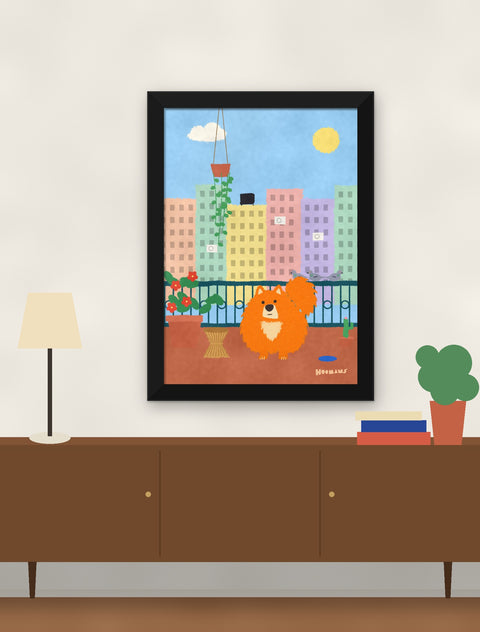 Black framed pomeranian poster hung above a walnut console with a lamp, books and a plant