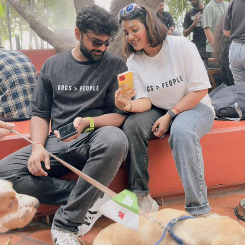 Real customer couple wearing the Dogs > People white and black oversized tees with their dog, Hoomans India