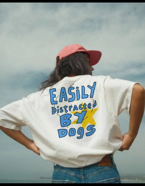 Real customer showing the Easily Distracted By Dogs back print on the off-white oversized tee by the sea, Hoomans India