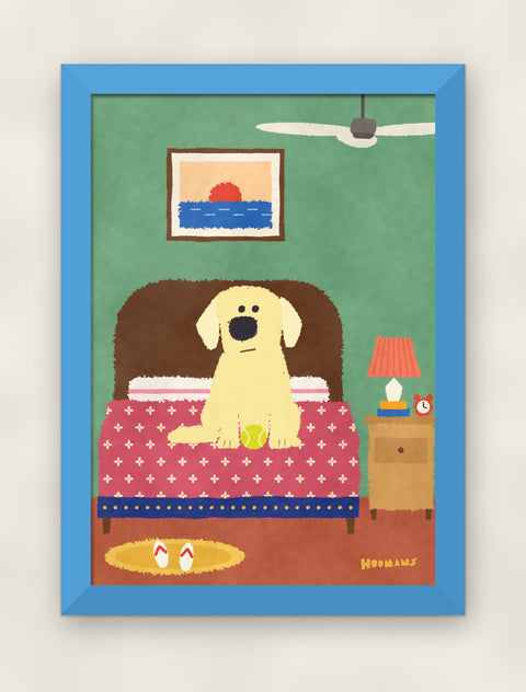 Labrador on the Bed art print in a sky blue frame on a plain wall