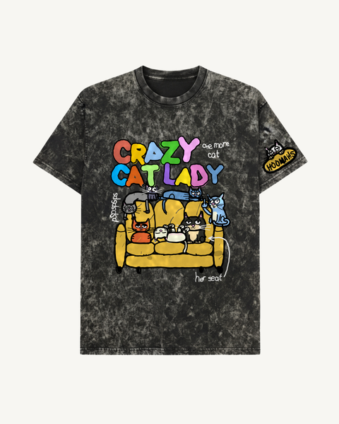 Black Crazy Cat Lady V2 acid wash oversized tee, seven cats taking over a mustard sofa, front flat lay