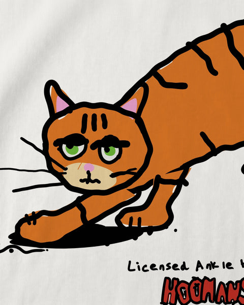 Close-up of the crouching orange tabby and the hoomans logo printed on white cotton