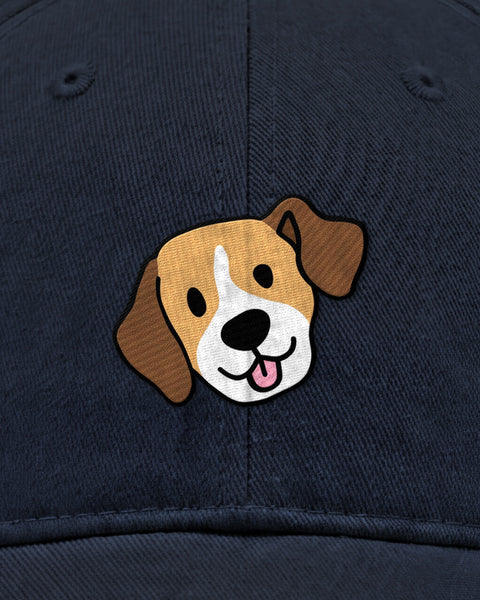 Embroidered beagle face in satin stitch on a navy blue baseball cap, close up