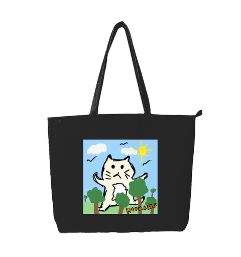Big Cat Energy black cotton tote bag printed with a giant cream cat sitting in a park of tiny trees under a yellow sun