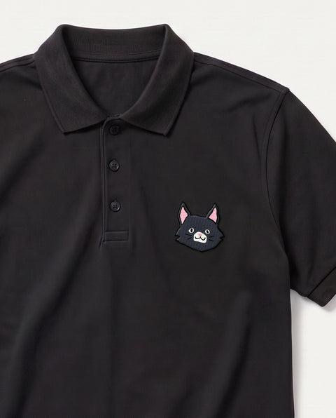 Black embroidered black cat polo, close-up of collar, button placket, and satin-stitch chest patch