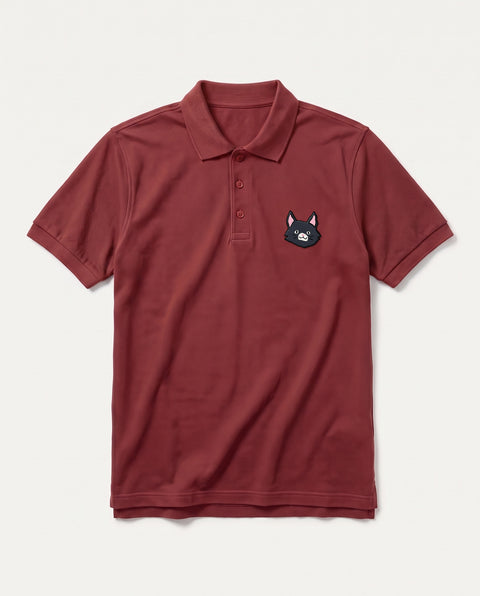 Brick Red polo shirt with embroidered black cat face on the chest, front flat lay