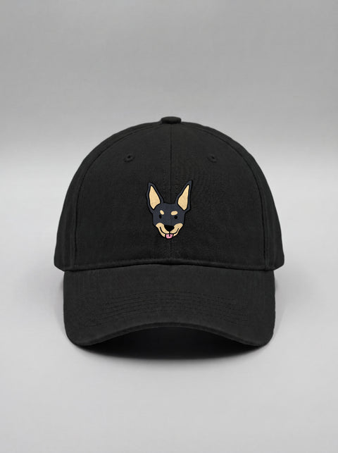 Black baseball cap with embroidered black indie dog face, front view