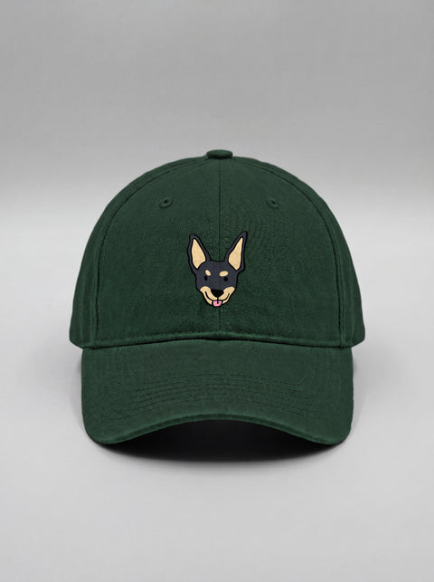 Bottle green baseball cap with embroidered black indie dog face, front view