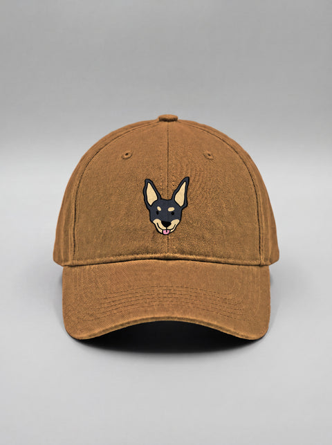Khaki baseball cap with embroidered black indie dog face, front view