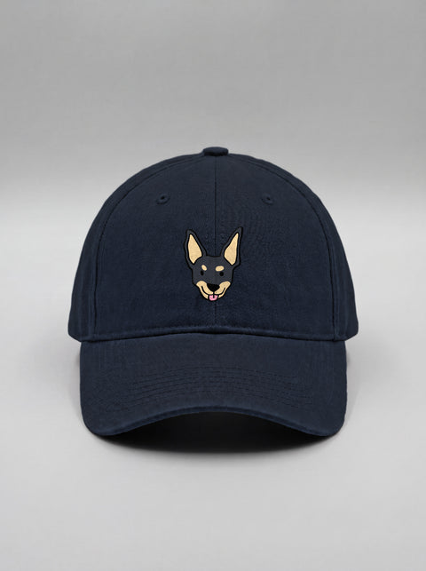 Navy blue baseball cap with embroidered black indie dog face, front view