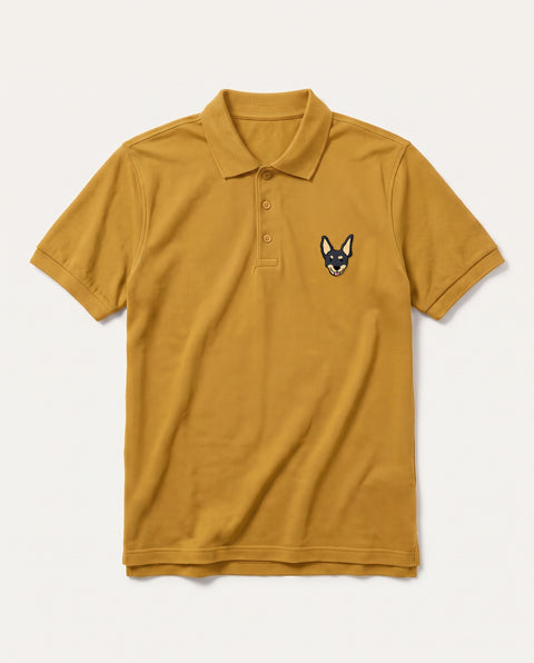 Mustard Yellow polo shirt with embroidered black indie dog face on the chest, front flat lay