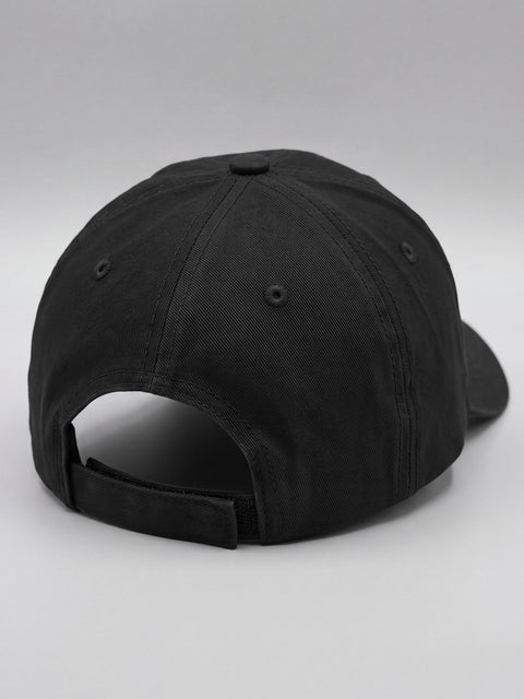 Back of the black cap with the adjustable hook-and-loop strap