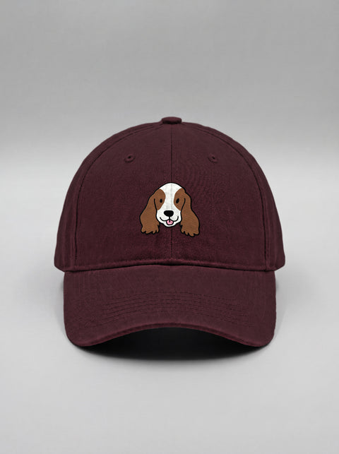 Maroon baseball cap with embroidered cocker spaniel face, front view