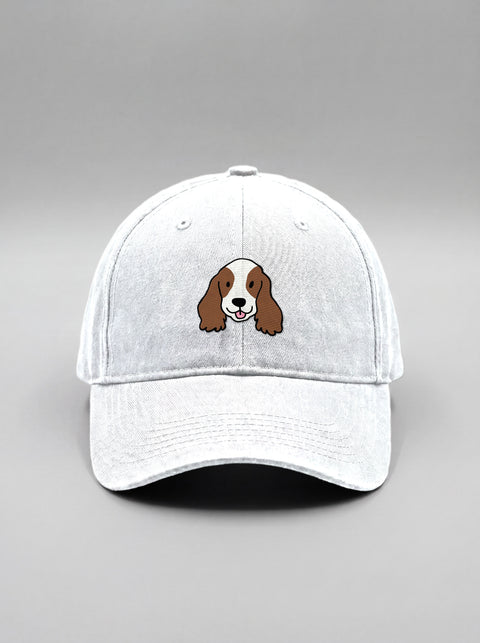 White baseball cap with embroidered cocker spaniel face, front view