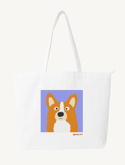 White large canvas tote bag with a flat colour Corgi face on a periwinkle block and a ginger Hoomans wordmark, front view