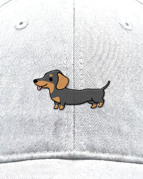 Embroidered full-body dachshund in satin stitch on a white baseball cap, close up