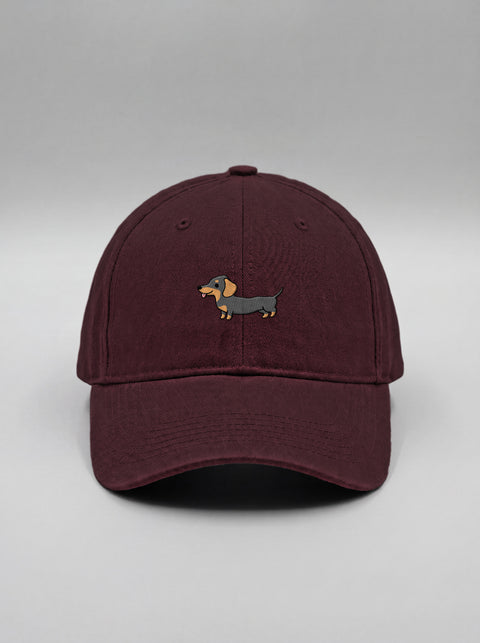 Maroon baseball cap with embroidered full-body dachshund, front view