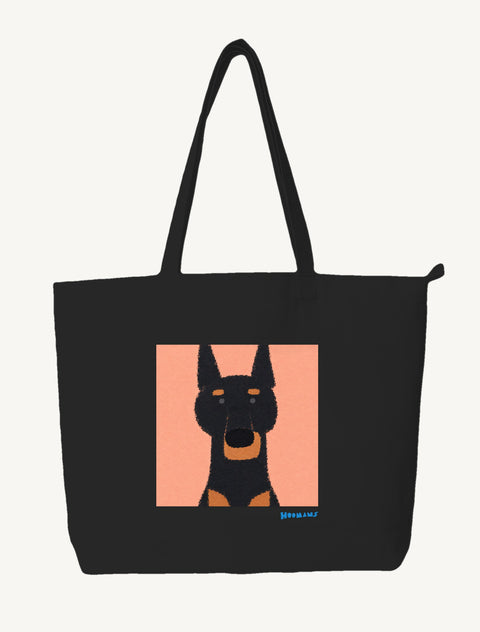 Black large canvas tote bag with a flat colour black and tan Doberman on a peach block and a cerulean blue Hoomans wordmark, front view