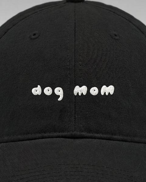 Close-up of the embroidered white dog mom lettering on the front of the black cap