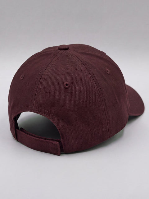 Back of the maroon cap with the adjustable hook-and-loop strap