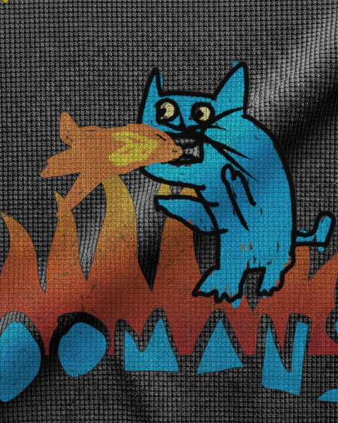 Close-up of the blue fire-breathing cat and the flames printed on black waffle knit, the ink sitting down in the knit