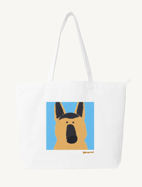 White large canvas tote bag with a flat colour German Shepherd face on a sky blue block and an amber Hoomans wordmark, front view