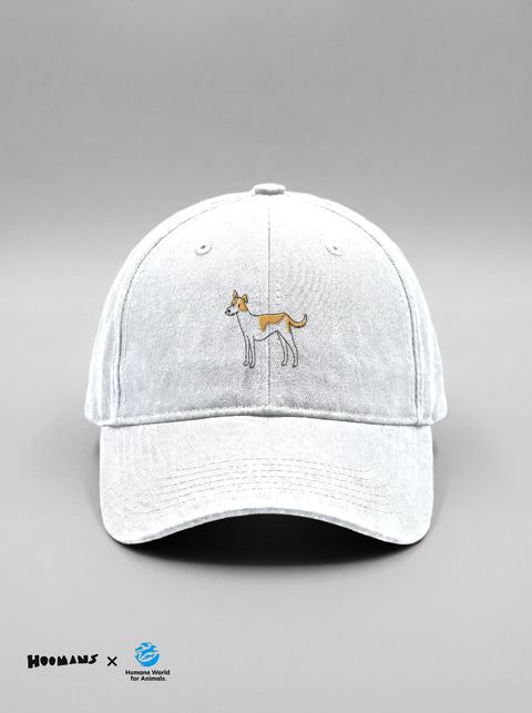 Gillu white cotton cap with a small embroidered tan indie dog on the front panel