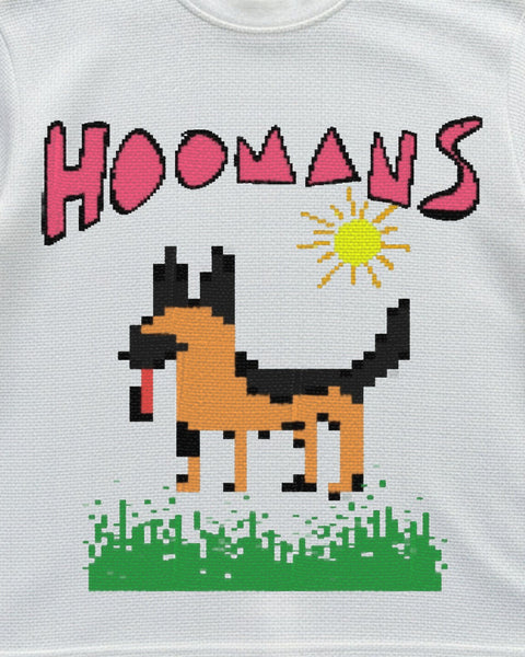 Close up of the pixel german shepherd print with a yellow sun, green grass and pink HOOMANS lettering on off-white waffle knit