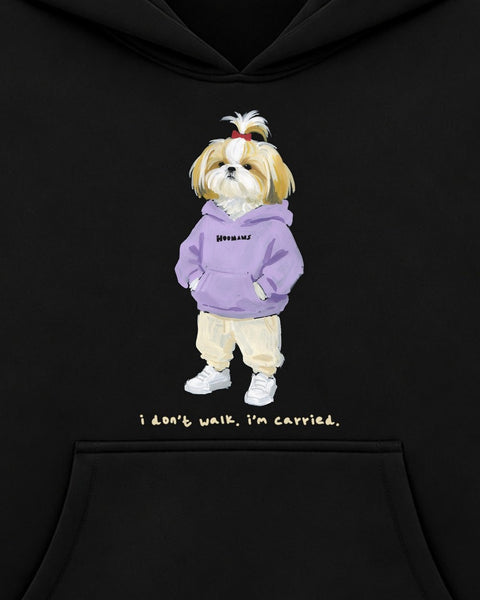 Close up of the chest print: a shih tzu with a red bow in a lavender HOOMANS hoodie, chin up, above 'i don't walk. i'm carried.'