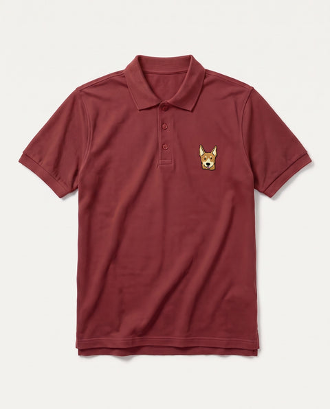 Brick red polo shirt with embroidered Indian indie dog face on the chest, front flat lay