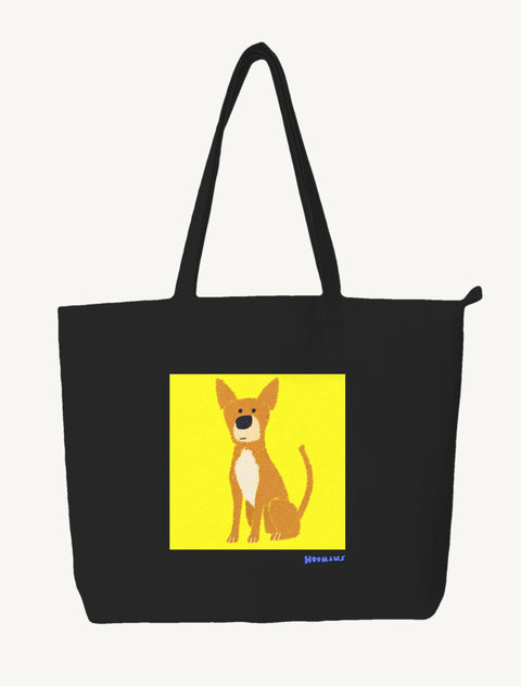 Black large canvas tote bag with a flat colour Indie dog sitting on a bright yellow block and a royal blue Hoomans wordmark, front view