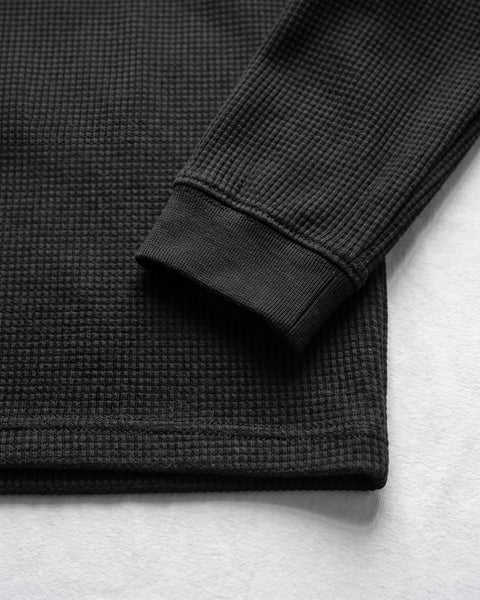 Sleeve cuff and hem of the black waffle knit full sleeve tee